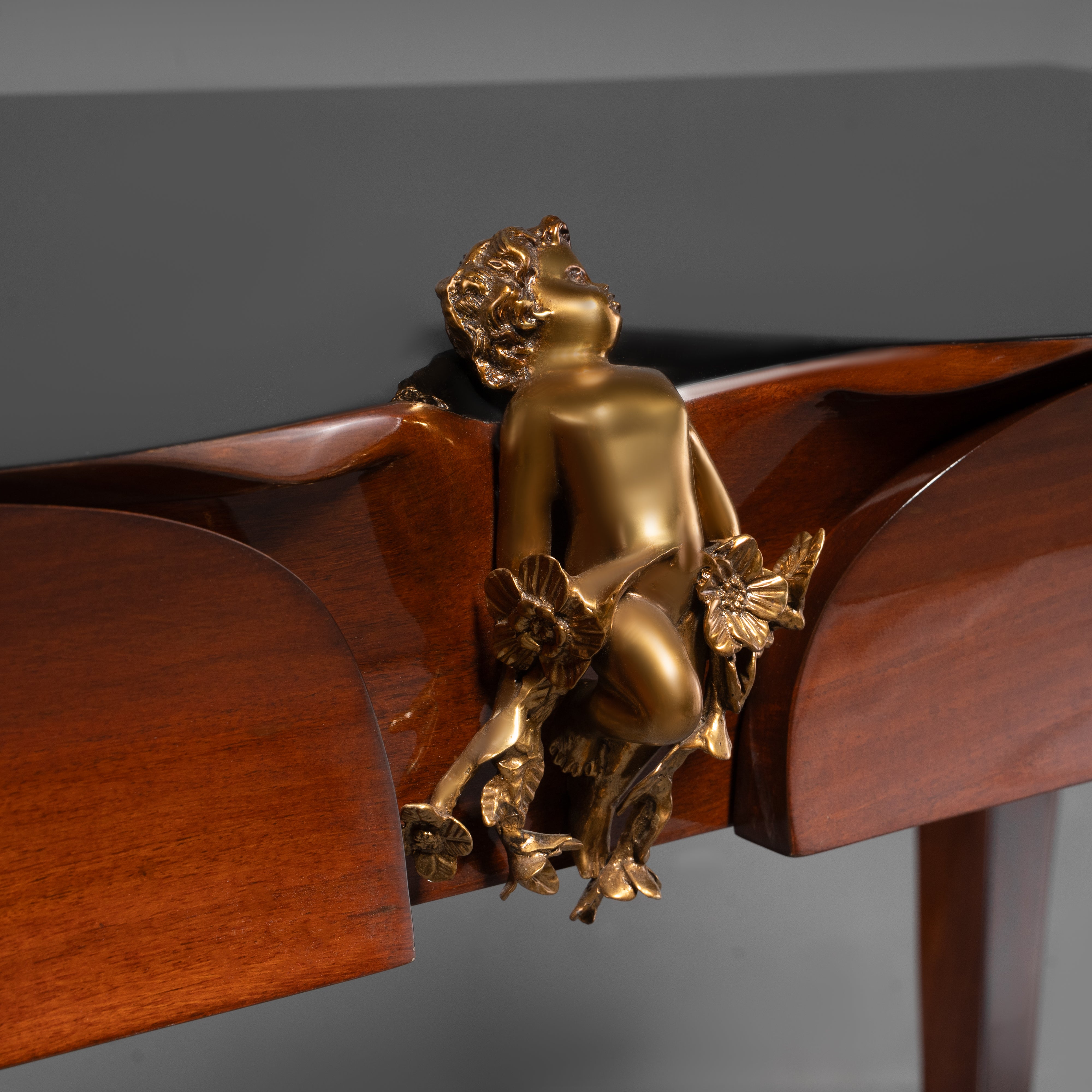 Rococo Revival Style Console Table with Gilt Cherub Ornament and Black Lacquer Top