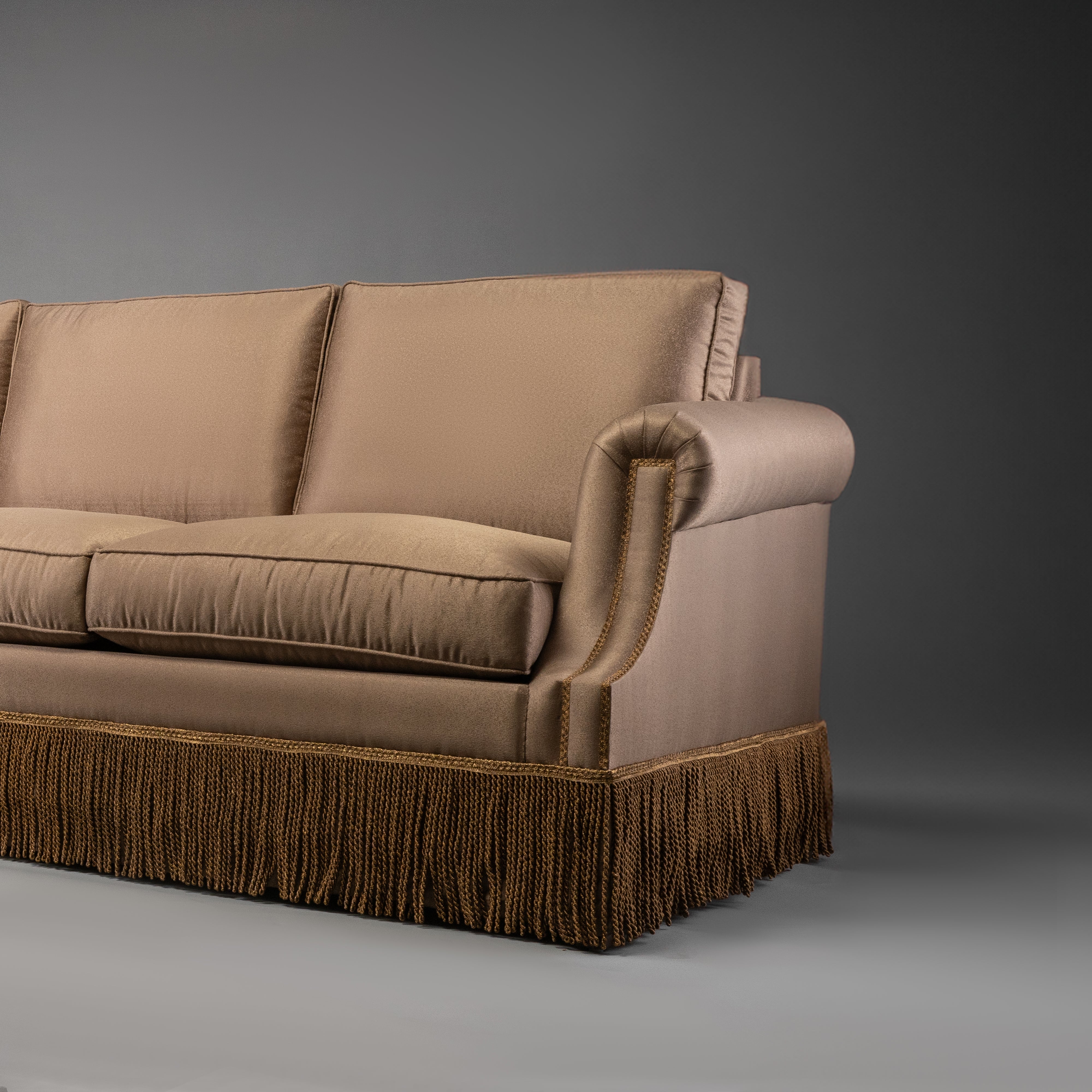 Classic Taupe Sofa with Rolled Arms and Decorative Fringe Skirt