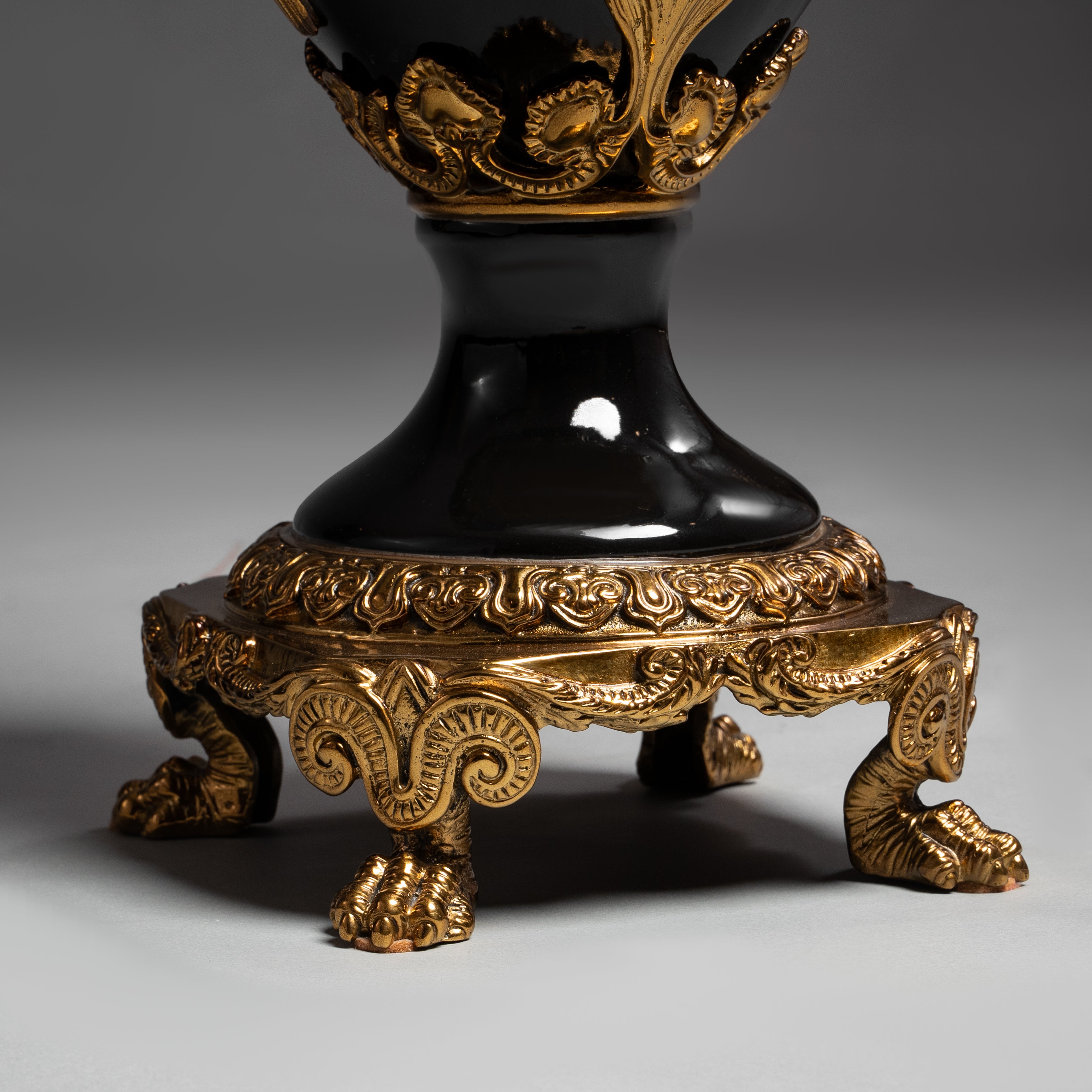 Elegant Black and Gold Neoclassical Vase with Winged Figures