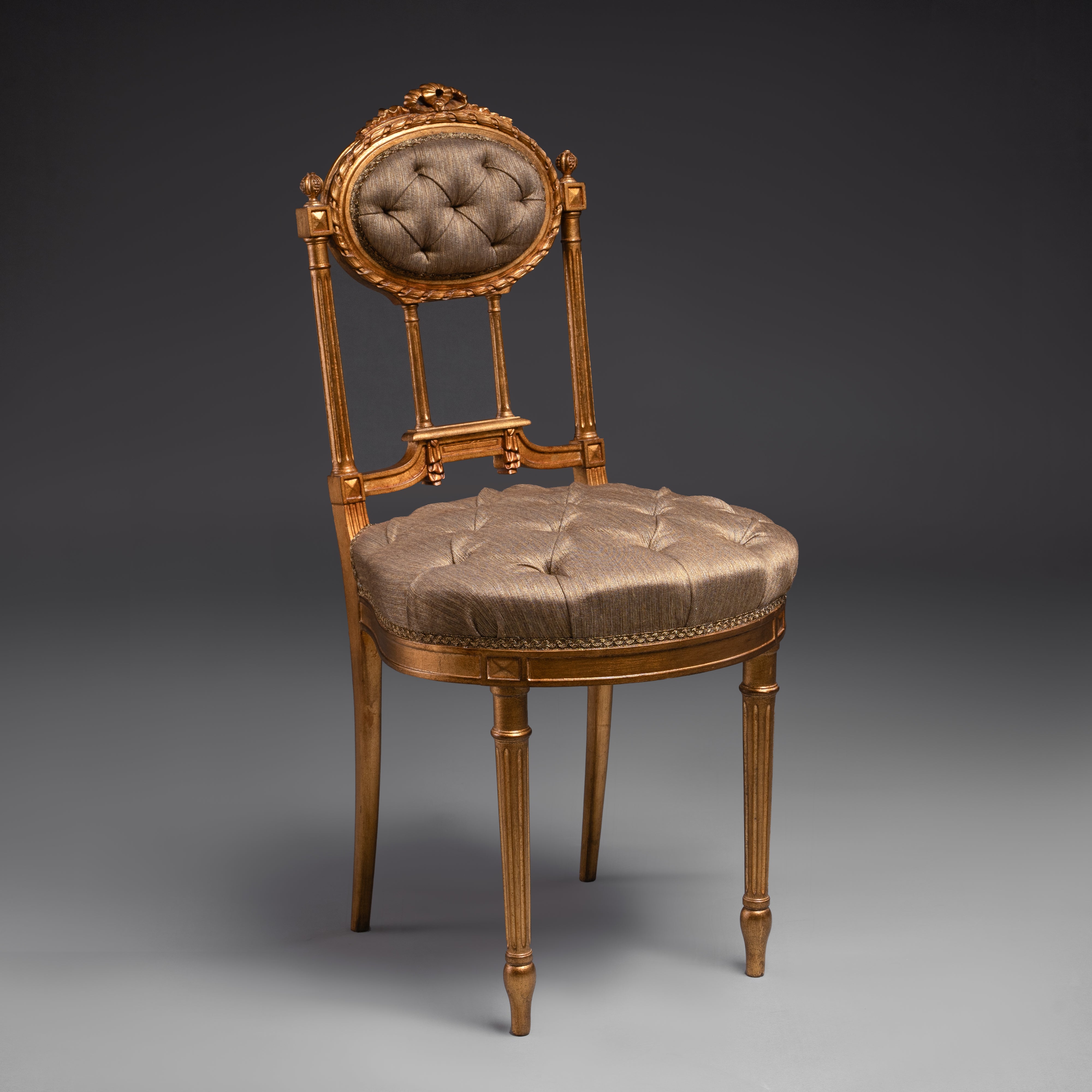 Opulent tufted chair with gilded accents and  regal charm.