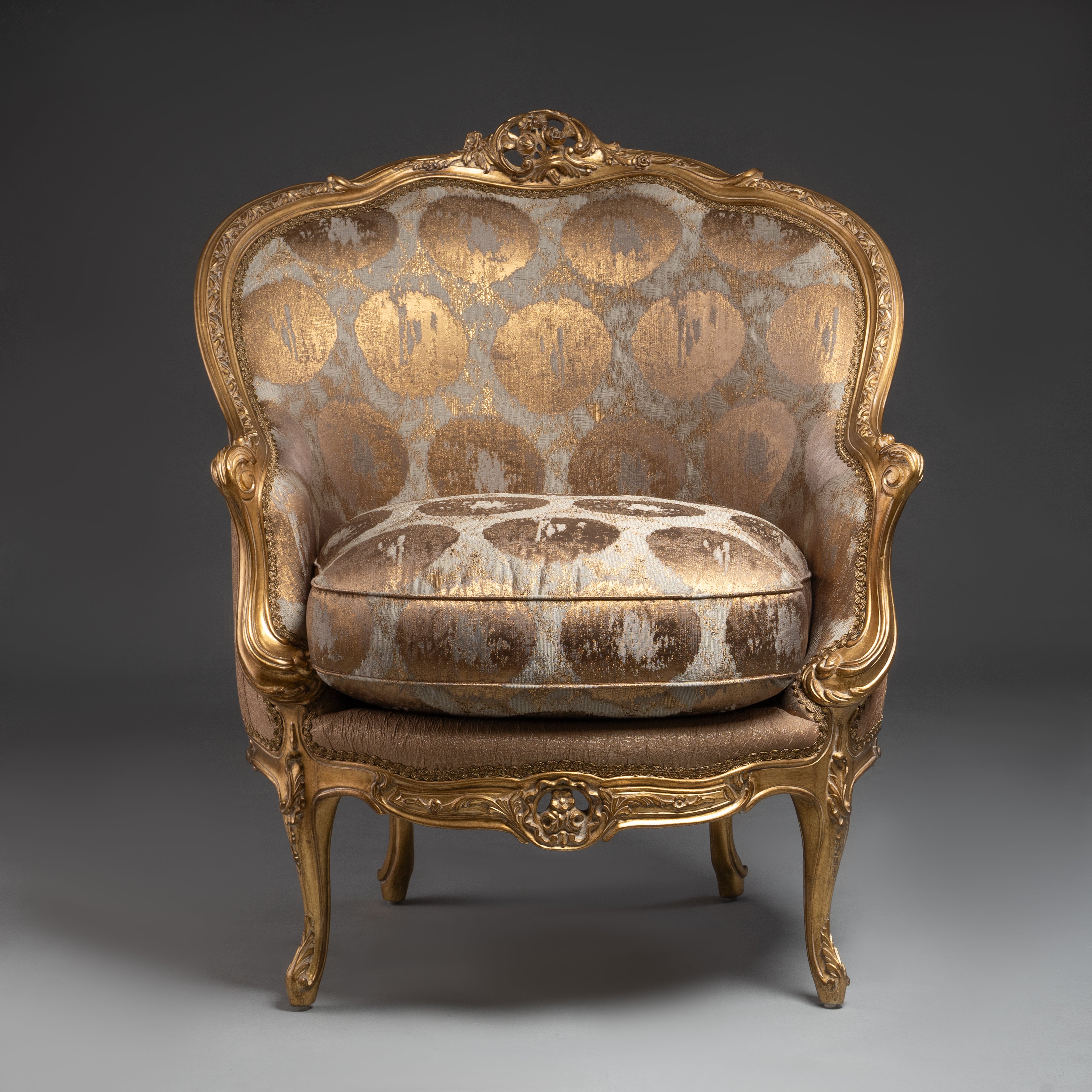 A lavishly upholstered Louis XV-style  armchair with gilded elegance